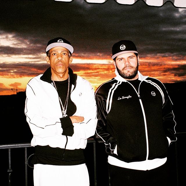 Chris Ivery is wearing a white tee, white jacket and white jogger.